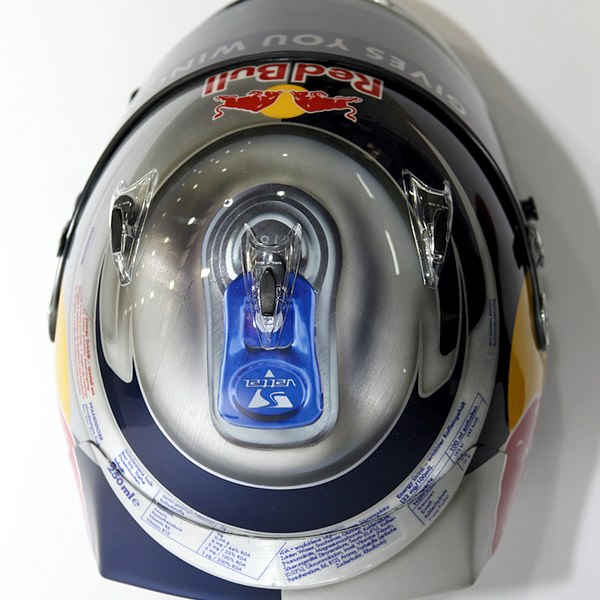 The top of Sebastian Vettel's helmet shows lid of a Red Bull can including blue ring pull.