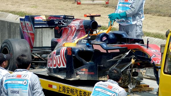 Sébastien Buemi's Toro Rosso returns to the pit lane with a few less pieces than it left with.