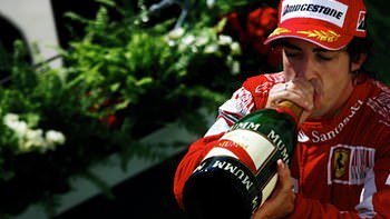 Fernando Alonso enjoys a drop of champagne.
