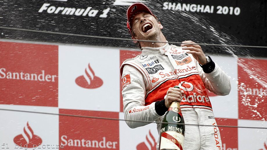 Button celebrates on the podium in Shanghai