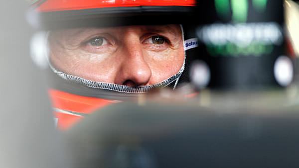 Michael Schumacher sits in the garage