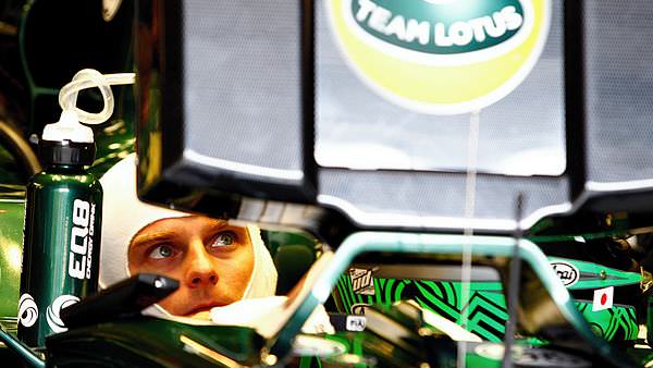 Heikki Kovalainen ponders the times from the comfort of the car