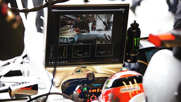 Michael Schumacher watches himself on screen in the garages of Germany