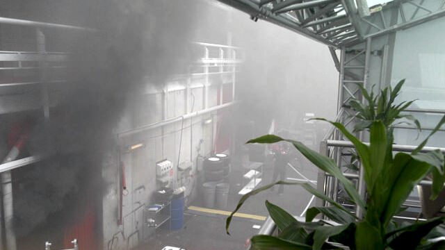 Smoke pours from the rear of the garage