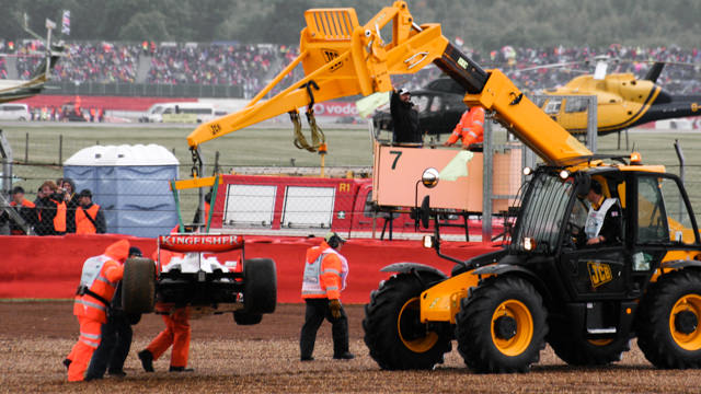 Marshals extract a beached Force India at Silverstone