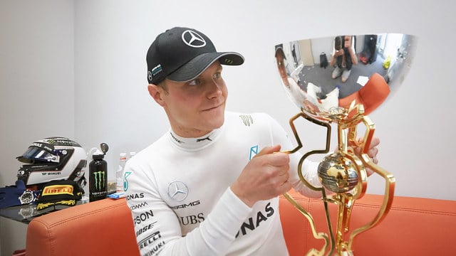 Bottas gazes at his first F1 winner's trophy
