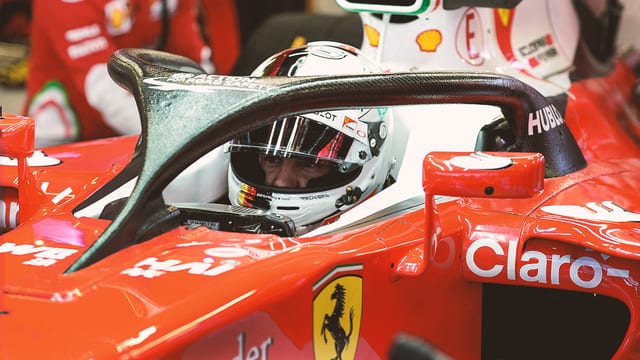 Vettel peers around the halo protection device